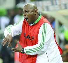 A very high spirited Stephen Keshi, seems to be either shouting or dancing.